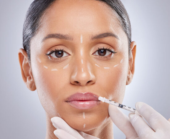 Shot of an attractive young woman getting lip filler injections in the studio.